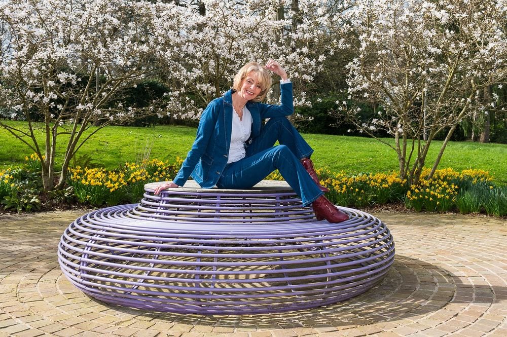 A stylish shoot for Midlife Magic, posed on a wire seat at Rudding Park.