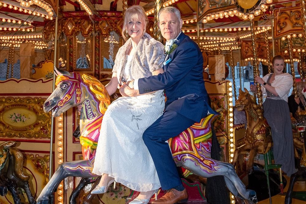 Wendy & Barry on a carousel after their winter wedding at Bedern Hall, York.