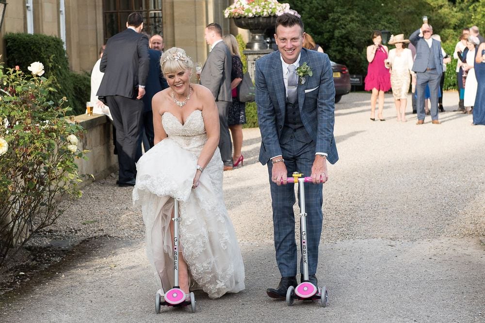 Elaine & Matty whizz about on the flower girls' scooters.