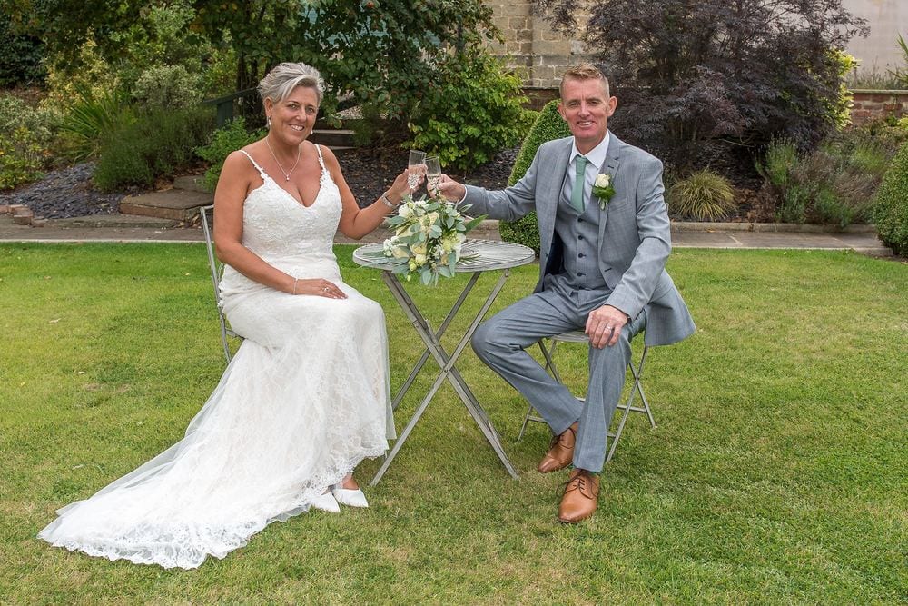 Helene & Rob relax in the gardens of Burythorpe House.