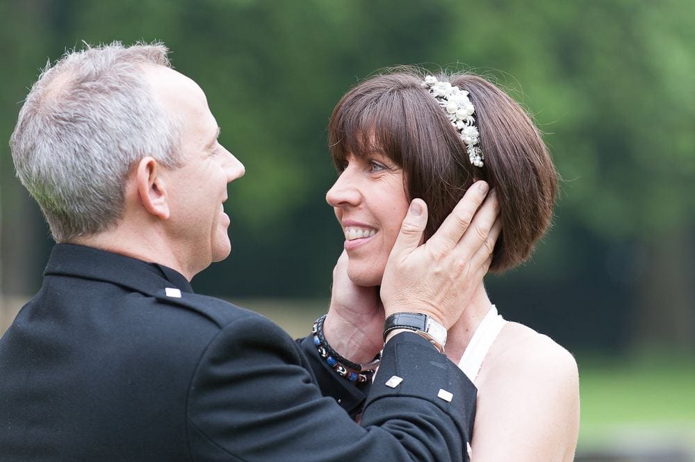 Groom Murray tenderly holds Jess's face after their wedding at York Register Office.