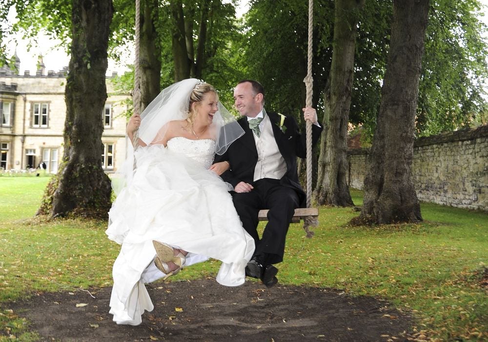 Newly-weds Laura & Craig have fun on a tree swing at The Old Lodge, Malton.