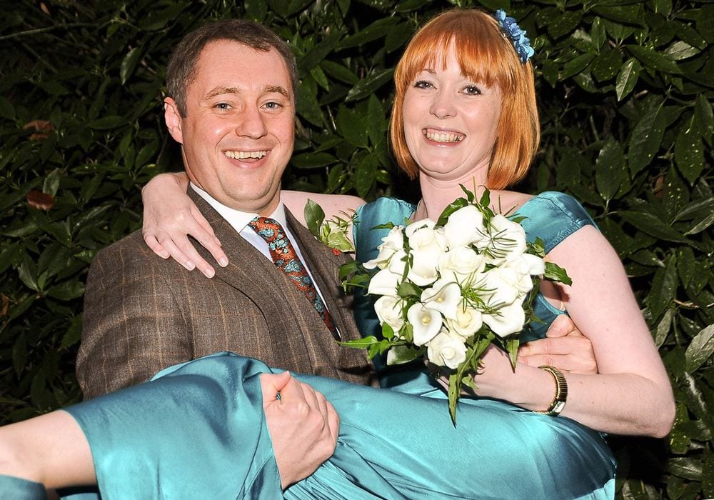 Tom scoops his bride Sara into his arms after their wedding at York Register Office.
