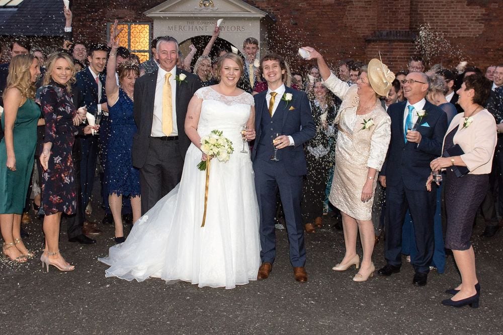 Wedding guests throw confetti outside Merchant Taylors' Hall, York.