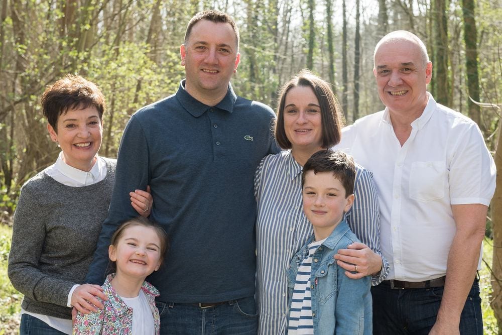 A multi-generational family portrait – grandparents, parents and children – in a Yorkshire forest setting.